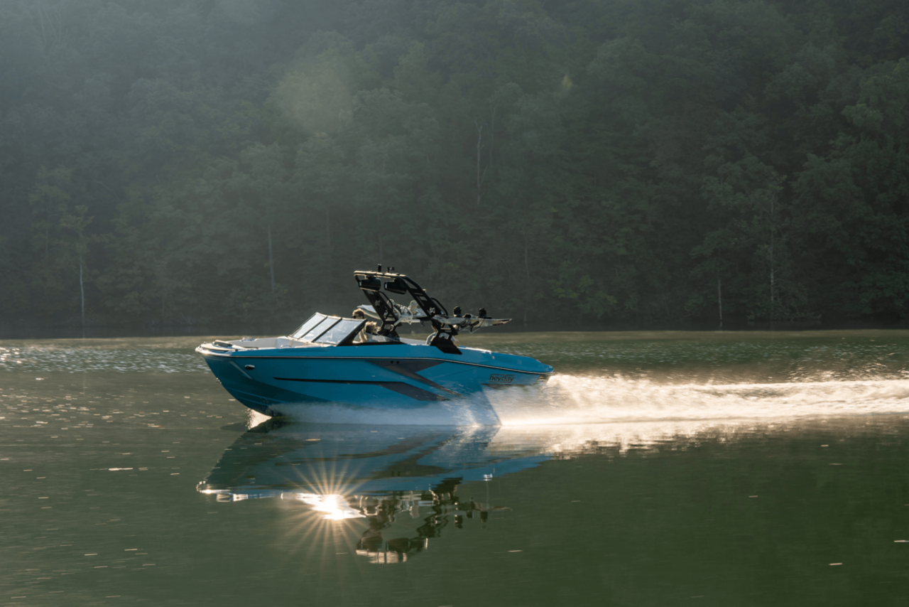 Man Driving Heyday Wake Boat, Port View, Boat Underway