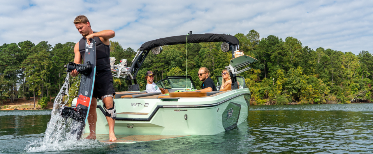 Man standing on the back of an H22 wake boat