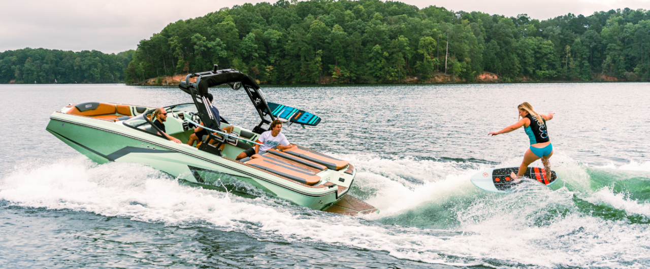 woman wakesurfing behind a Heyday boat